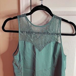 Green tank with flower lacing on top